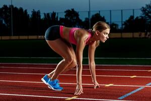 Portrait of beautiful woman ready to start running. photo