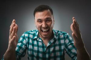 Portrait of man on gray background. Man showing different emotions. photo