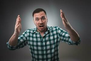 Portrait of man on gray background. Man showing different emotions. photo