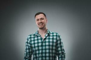 Cheerful man laughing and looking at camera with a big grin. photo