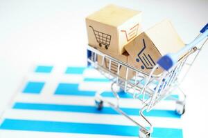 Online shopping, Shopping cart box on Greece flag, import export, finance commerce. photo