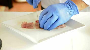 Hands of professional chef slicing fish video