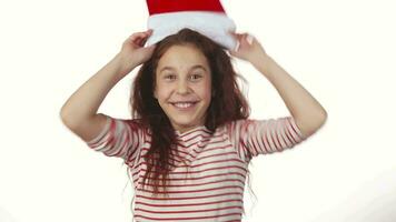 The happy girl trying on a Santa Claus hat video
