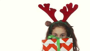 A sweet girl hides behind a Christmas gift box video