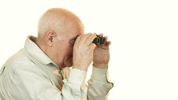 Happy grandfather smiling to the camera after looking away using binoculars video