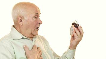 Senior man looking shocked checking time on alarm clock video