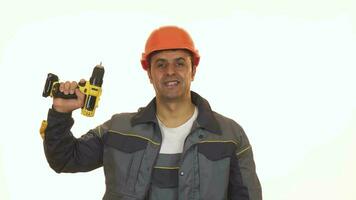 Happy mature industry worker in hardhat showing thumbs up holding drill video