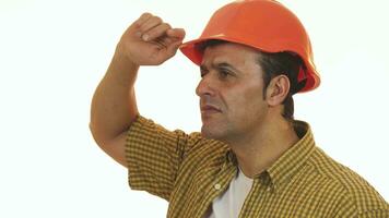 Mature professional builder in hardhat looking disappointed video