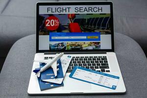 Boarding pass, passport and toy aircraft on desk top view photo