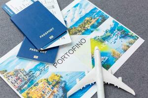 White blank model of passenger plane on passports with boarding pass on blue rustic wooden background photo