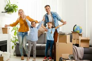 Family with cardboard boxes standing in row at home photo