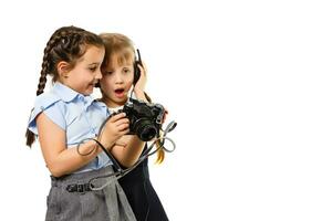 Two curious friendly schoolgirls watching photos at break