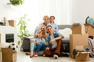 big family moving into a new apartment. Room with empty walls, new beginning. photo