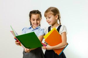 Two little schoolgirls. Education, fashion, friendship concept. photo