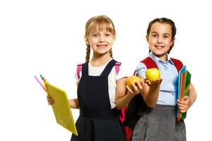 Two little schoolgirls. Education, fashion, friendship concept. photo