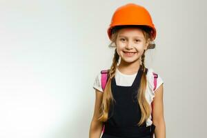 Little girl are wearing protective helmet on white background photo