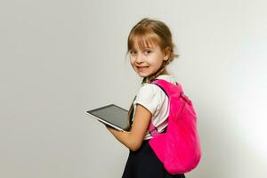 little blond school girl with backpack bag portrait isolated on white background photo