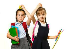 Portrait of two people nice cute lovely charming dreamy attractive cheerful pre-teen girls siblings showing aside ad promotion copy space isolated background photo