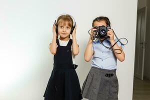 Profile side view photo of two small girls telling each other incredible stories for a break on white background