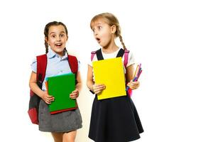 Two little schoolgirls. Education, fashion, friendship concept. photo