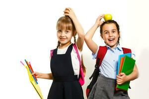 Two little schoolgirls. Education, fashion, friendship concept. photo