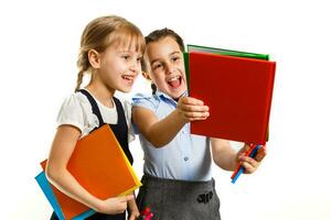 Two little schoolgirls. Education, fashion, friendship concept. photo