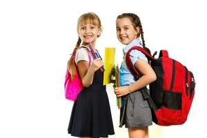 Two little schoolgirls. Education, fashion, friendship concept. photo