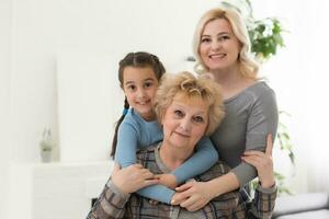 A little girl, mother and grandmother at home. photo