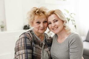 happy senior mother and adult daughter closeup portrait at home photo