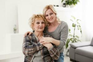 happy senior mother and adult daughter closeup portrait at home photo