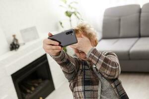 A crying elderly woman covering her face photo