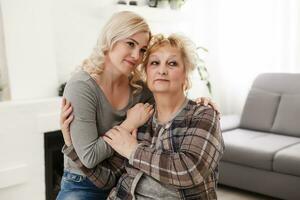 happy senior mother and adult daughter closeup portrait at home photo