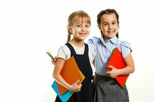 Two little schoolgirls. Education, fashion, friendship concept. photo