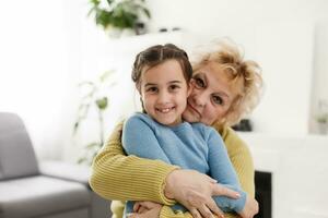 Grandmother and granddaughter portrait, embraced photo