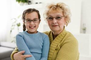 grandmother with granddaughter wearing glasses both photo