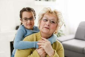 grandmother with granddaughter wearing glasses both photo