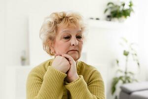 Portrait of senior woman with green sweater photo