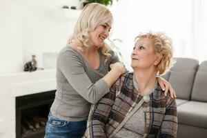 happy senior mother and adult daughter closeup portrait at home photo