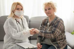 Senior woman with her home caregiver photo