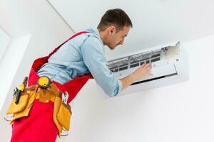 Adjuster air conditioning system sets a new air conditioner in the apartment. photo