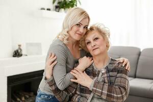 pretty woman and senior mother at home photo