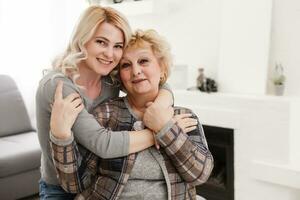 pretty woman and senior mother at home photo