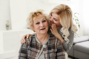 pretty woman and senior mother at home photo