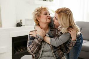 happy senior mother and adult daughter closeup portrait at home photo