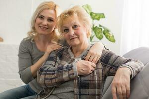 happy senior mother and adult daughter closeup portrait at home photo