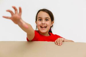 Happy girl opening present. Child excited with Christmas holiday gift concept. Kid looking inside cardboard box view. Teenager getting birthday surprise idea. Person with cheerful expression photo