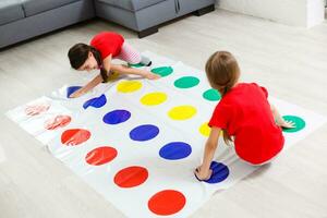 two little girls Having Fun Playing Game On Floor At Home. Siblings Friendship photo