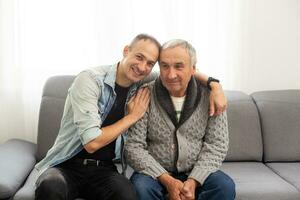 Portrait of grandfather and his teen grandson smiling. Isolated white background photo