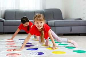 two little girls Having Fun Playing Game On Floor At Home. Siblings Friendship photo