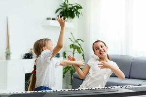 Home lesson on music for the girl on the piano. The idea of activities for the child at home during quarantine. Music concept photo